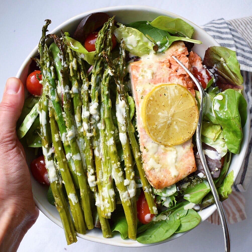 Salmon salad bowl with asparagus and creamy aioli drizzle