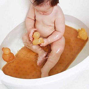 Baby in bath with Hevea natural rubber mat and duckies