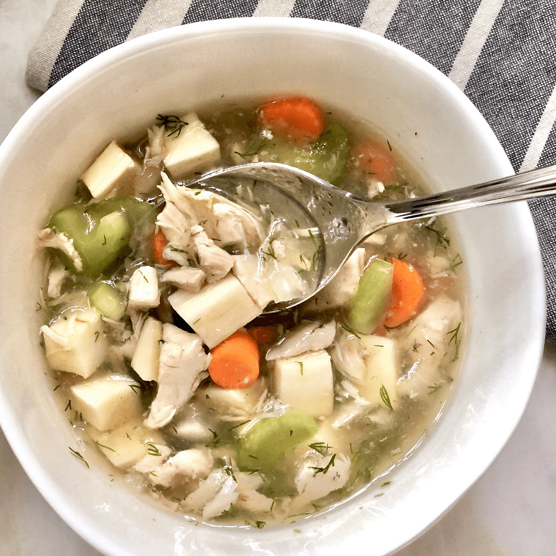 Bowl of soup_crop_2500 Bowl of Instant Pot chicken soup with vegetables and spoon