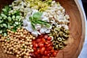 Italian chopped salad - chopped vegetables and mozzarella cheese on shredded lettuce.