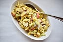 White ceramic bowl with healthy curry chicken salad.