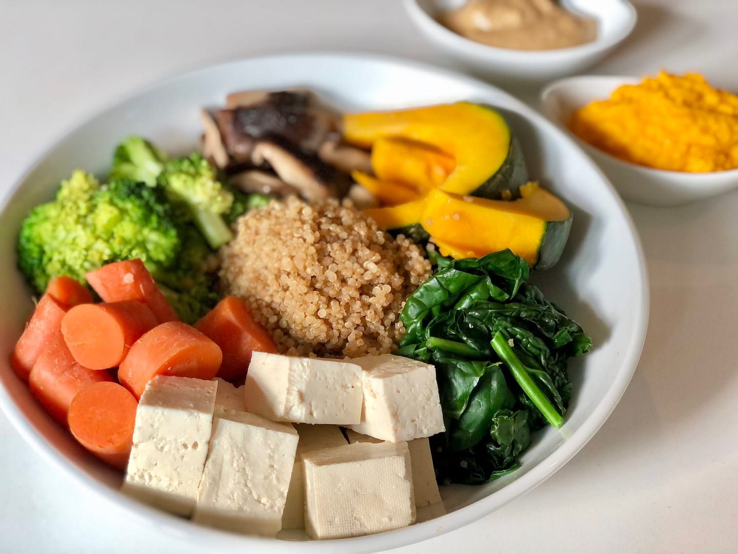 Plant lover's mighty macro plate - quinoa, mushrooms, squash, kale, tofu, carrot, & broccoli.